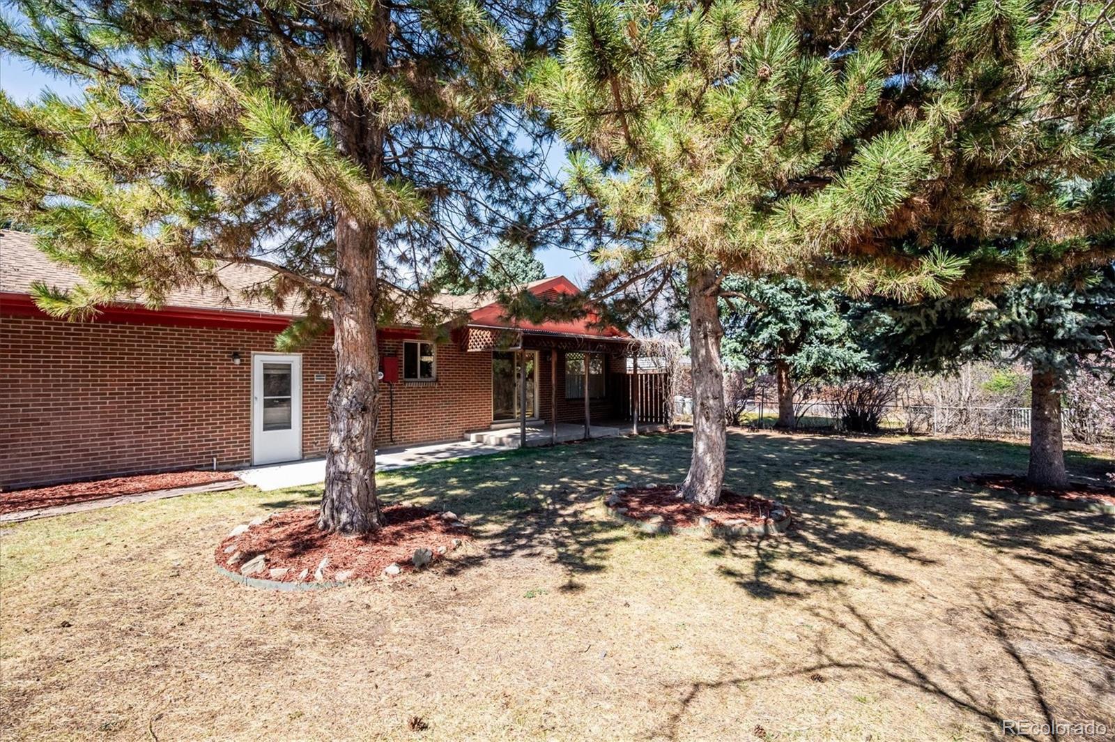 6640 South Williams Circle West Centennial, CO 80121 - Photo 21 of 23 a tree in front of a white house