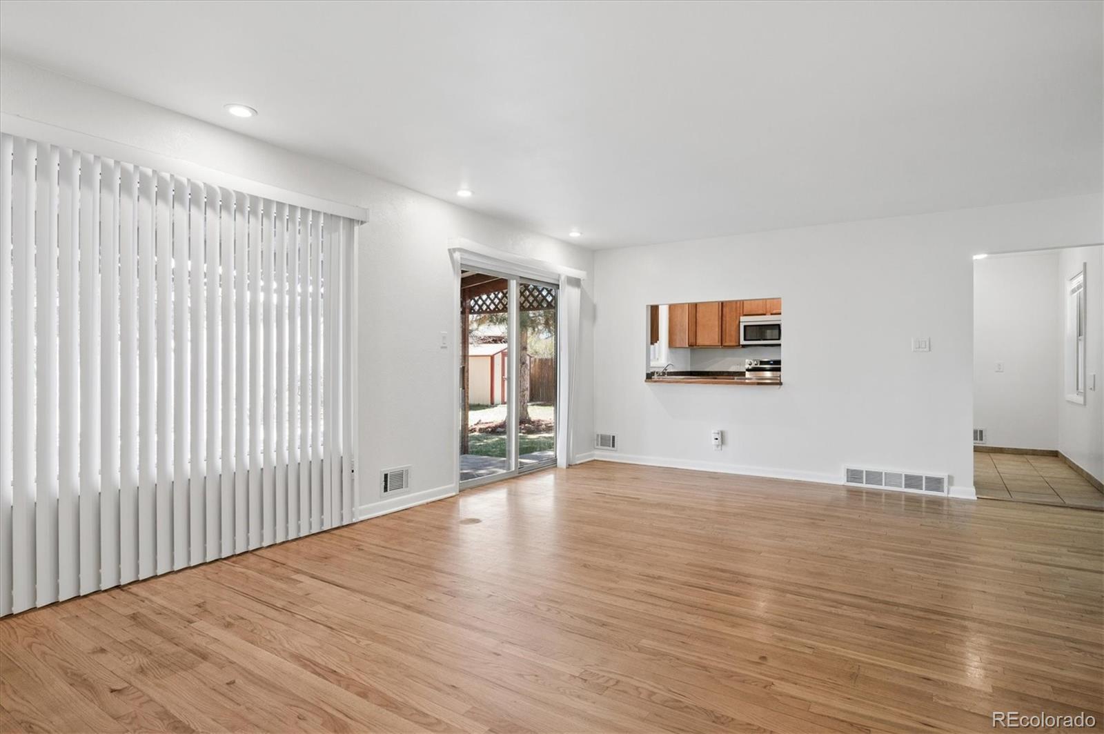 6640 South Williams Circle West Centennial, CO 80121 - Photo 4 of 23 a view of an empty room with wooden floor and a window