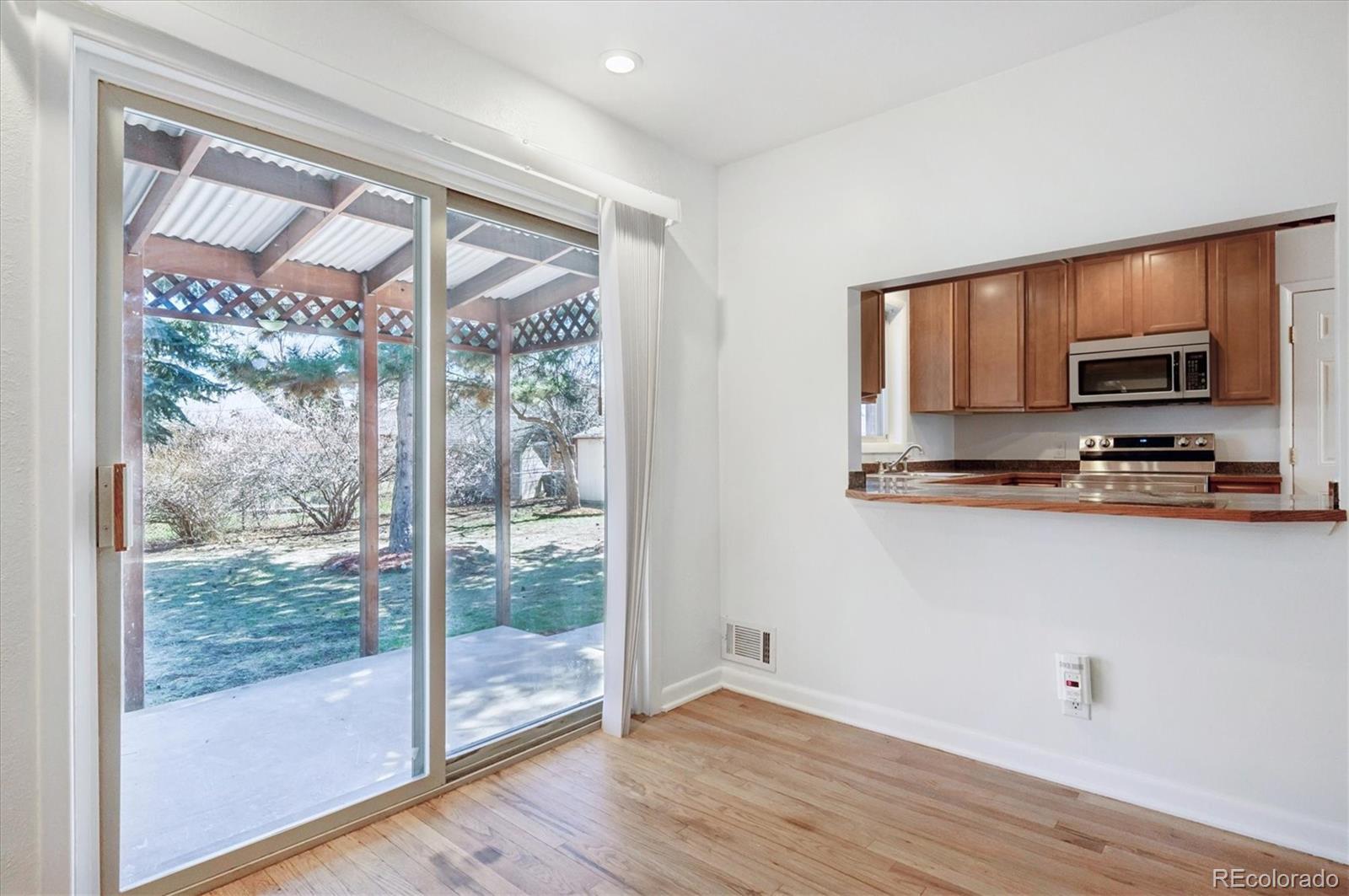 6640 South Williams Circle West Centennial, CO 80121 - Photo 5 of 23 a kitchen with a large window a microwave and outdoor view