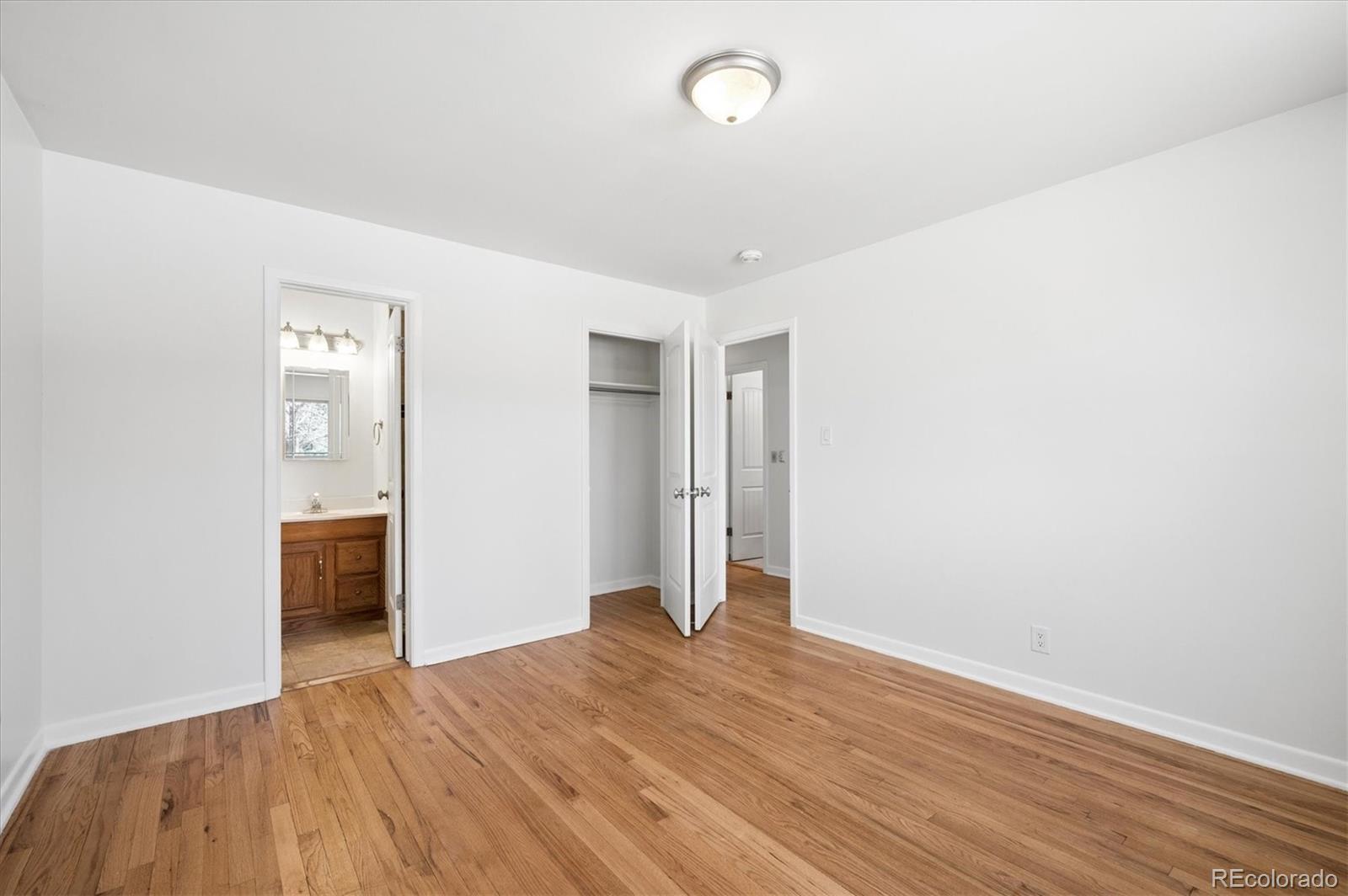 6640 South Williams Circle West Centennial, CO 80121 - Photo 10 of 23 an empty room with wooden floor and bathroom