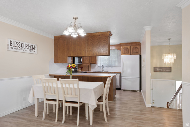 553 North 200 West Bountiful, UT 84010 - Photo 6 of 26 Dining area with suspended lighting, ornamental molding, and light wood finished floors