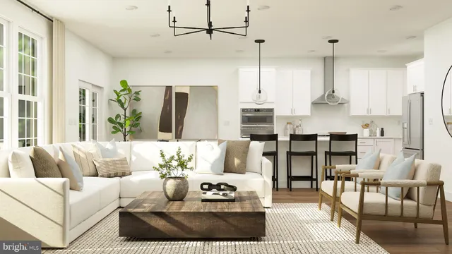 a living room with furniture white walls and kitchen view