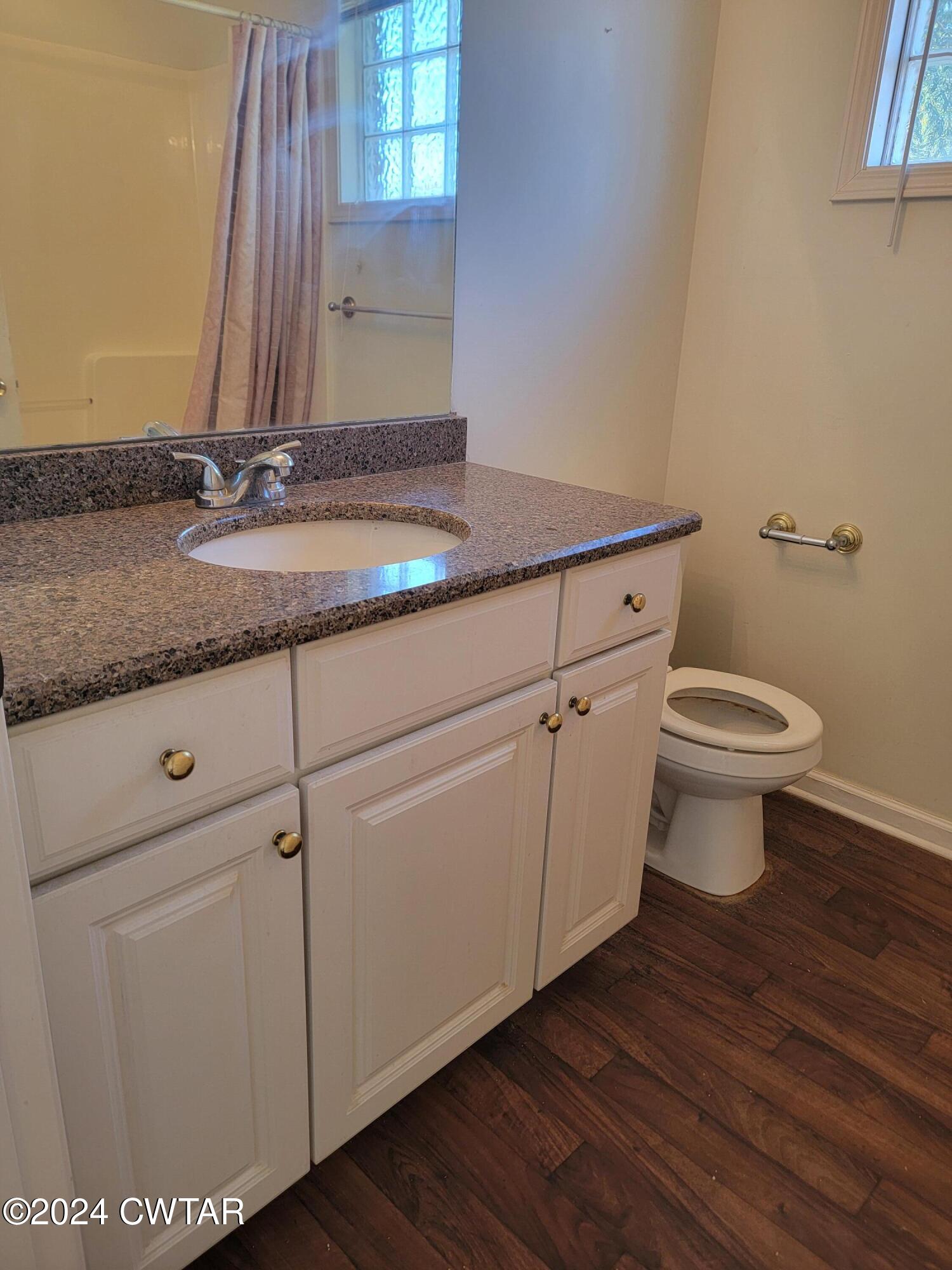 604 Gettysburg Drive Jackson, TN 38305 - Photo 16 of 22 a bathroom with a granite countertop toilet and a sink