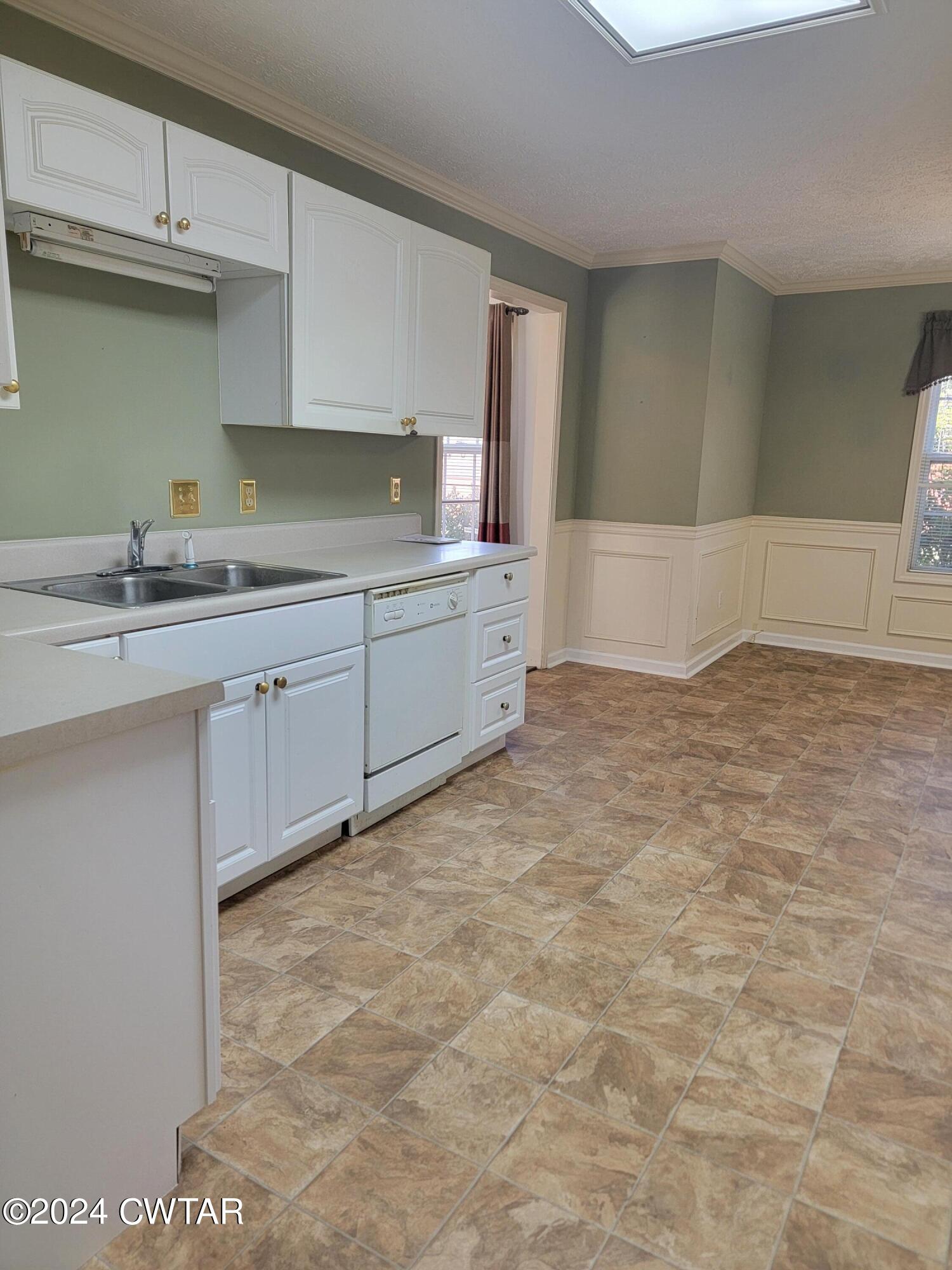 604 Gettysburg Drive Jackson, TN 38305 - Photo 4 of 22 a kitchen with granite countertop a sink and white cabinets
