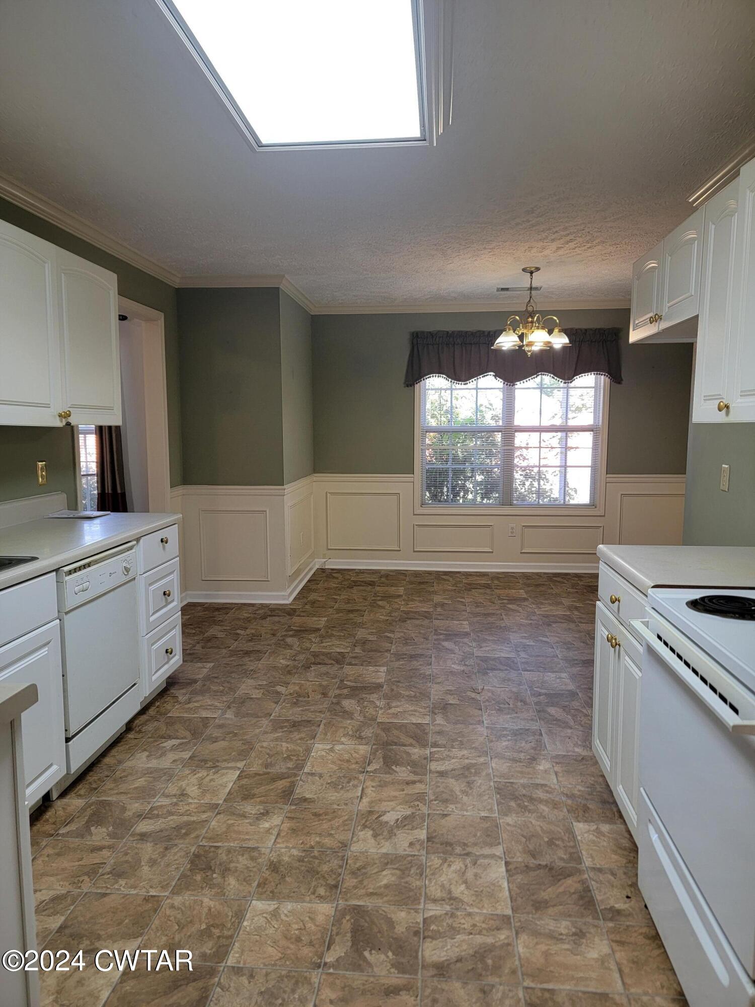 604 Gettysburg Drive Jackson, TN 38305 - Photo 6 of 22 a kitchen with granite countertop a stove a sink and a refrigerator