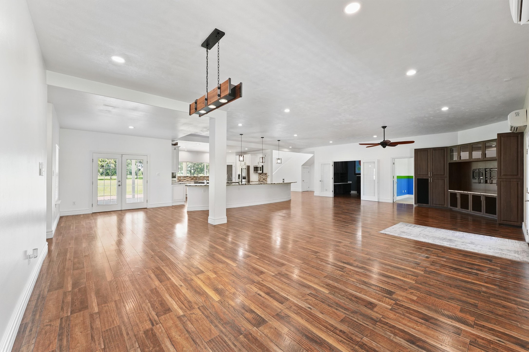 43919 Austin Branch Road Hempstead, TX 77445 - Photo 14 of 48 The formal dining area transitions effortlessly into a sunlit breakfast nook, creating a warm and welcoming space for meals of all kinds—from everyday breakfasts to holiday feasts. Framed by large windows, this area is flooded with natural light and offers peaceful views of the backyard. Just beyond, double doors open to your covered patio, extending your living and entertaining space outdoors.