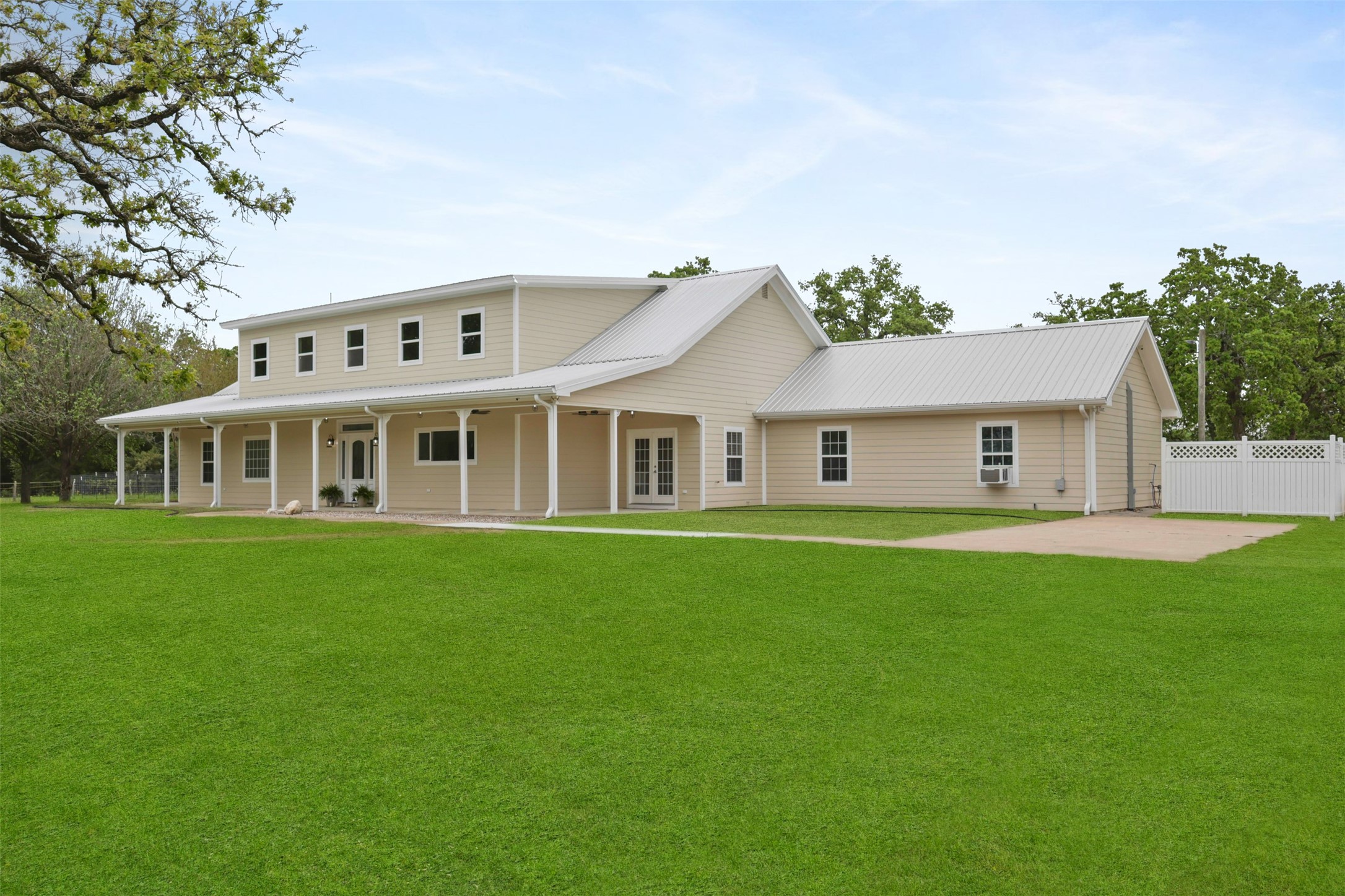 43919 Austin Branch Road Hempstead, TX 77445 - Photo 2 of 48 Enjoy the wide-open space, expansive yard, and beautiful architecture with a backdrop of blue skies and mature trees.