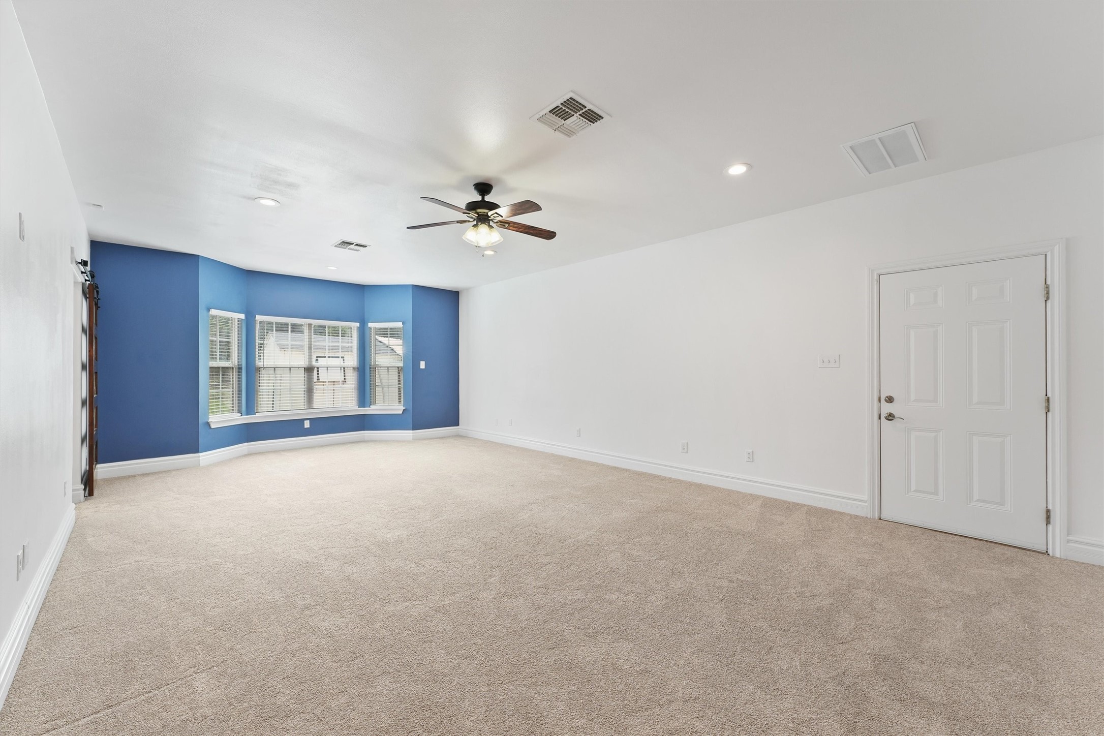 43919 Austin Branch Road Hempstead, TX 77445 - Photo 23 of 48 A tranquil, oversized primary retreat featuring soft carpet, designer finishes, and a stylish ensuite — your private countryside sanctuary.”A luxurious retreat. Also has private access to your covered back patio.