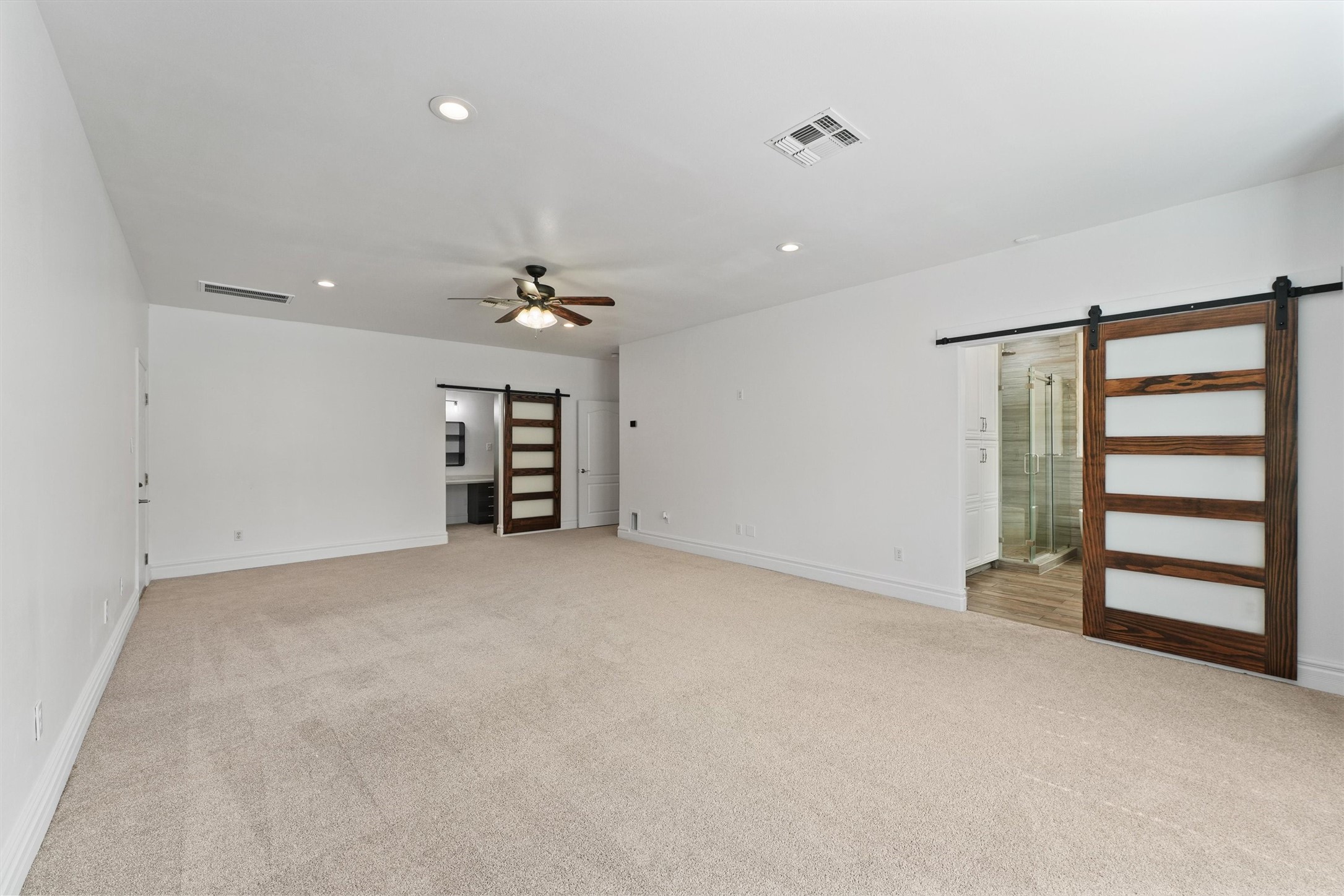 43919 Austin Branch Road Hempstead, TX 77445 - Photo 24 of 48 Look at all this space! Featuring your walk-in closet with vanity along with your expansive primary bathroom featuring sleek sliding doors.