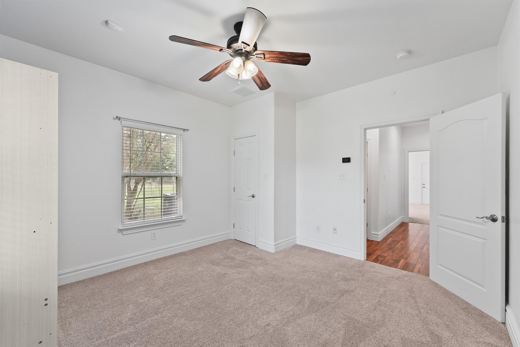 43919 Austin Branch Road Hempstead, TX 77445 - Photo 31 of 48 This thoughtfully designed second bedroom maximizes space and functionality with a convenient Murphy bed, perfect for guests or a versatile home office setup. The tailor-made closet provides ample storage with custom shelving and organization, keeping the room neat and inviting. Whether used as a guest room, study, or hobby space, this room adapts effortlessly to your lifestyle needs.