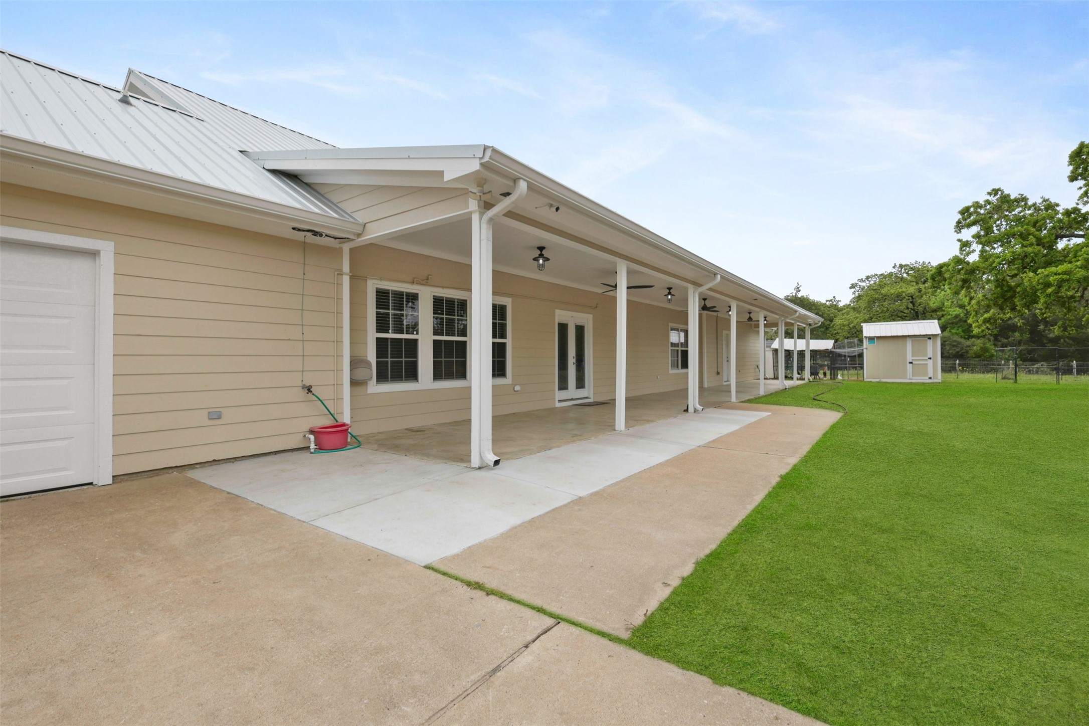 43919 Austin Branch Road Hempstead, TX 77445 - Photo 37 of 48 This spacious covered porch is the perfect outdoor retreat, complete with overhead lighting and ceiling fans for year-round comfort. Whether you're sipping sweet tea in the summer or enjoying a cozy fall evening, this space offers the ideal blend of comfort and country charm.