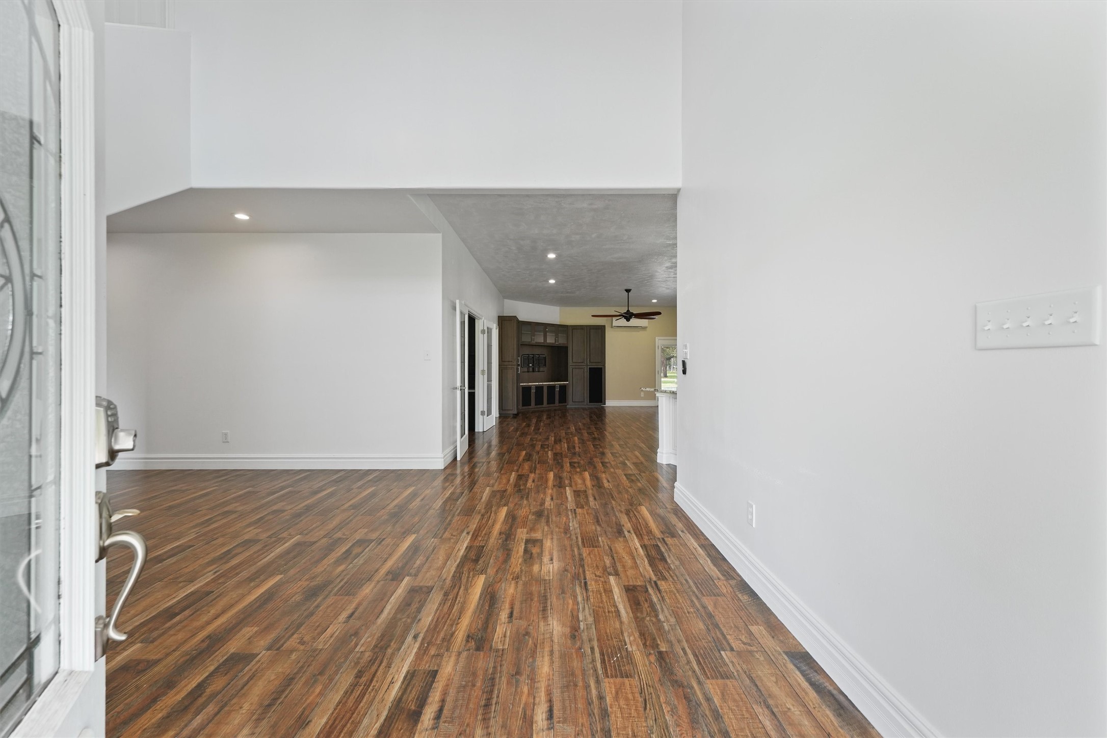 43919 Austin Branch Road Hempstead, TX 77445 - Photo 8 of 48 From the moment you walk through the front door, this one-of-a-kind custom farmhouse makes an unforgettable impression. Greeted by soaring 19-foot ceilings and a dramatic, designer light fixture that floats above the grand entryway, the tone is set for elevated country living. The open-concept design flows effortlessly, combining timeless farmhouse charm with upscale finishes and thoughtful architectural details throughout.