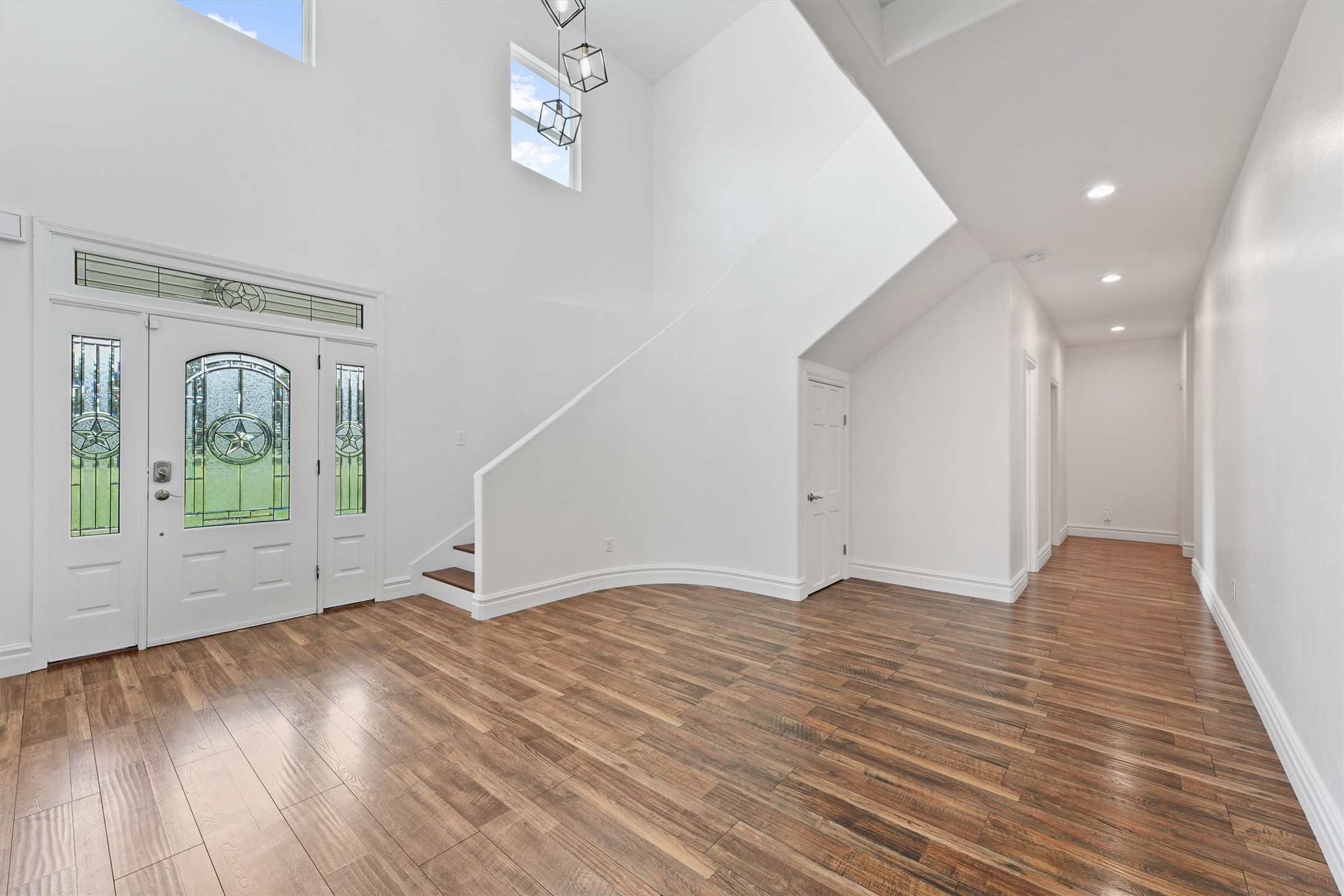 43919 Austin Branch Road Hempstead, TX 77445 - Photo 9 of 48 From the moment you walk through the front door, this one-of-a-kind custom farmhouse makes an unforgettable impression. Greeted by soaring 19-foot ceilings and a dramatic, designer light fixture that floats above the grand entryway, the tone is set for elevated country living. The open-concept design flows effortlessly, combining timeless farmhouse charm with upscale finishes and thoughtful architectural details throughout.
