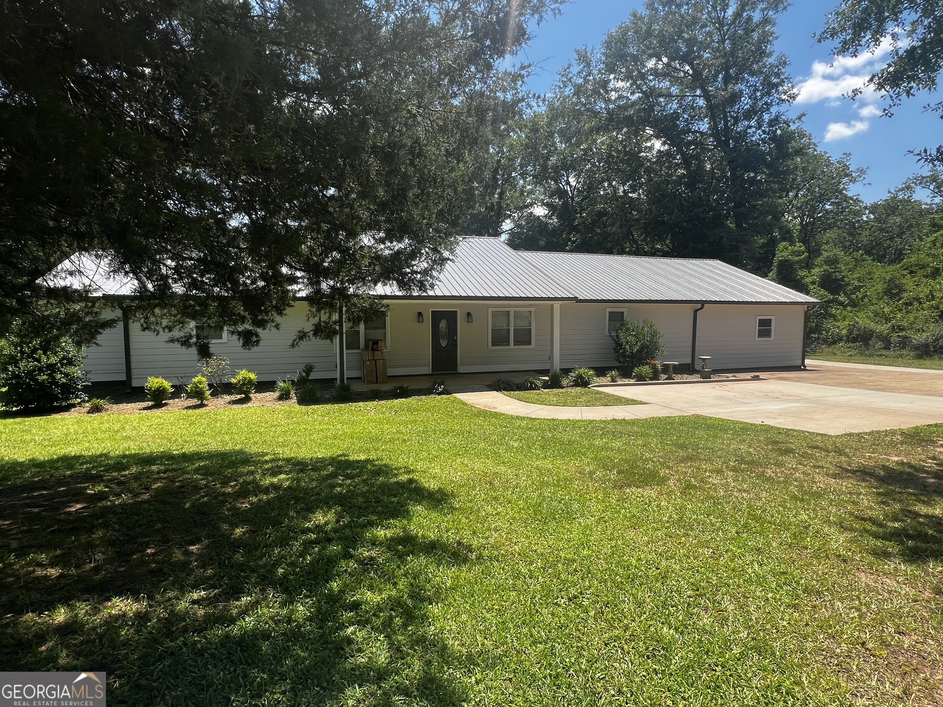 a swimming pool with outdoor seating and yard