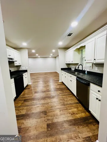 a large kitchen with granite countertop lots of counter top space
