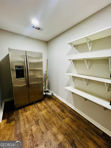 a view of a room with wooden floor