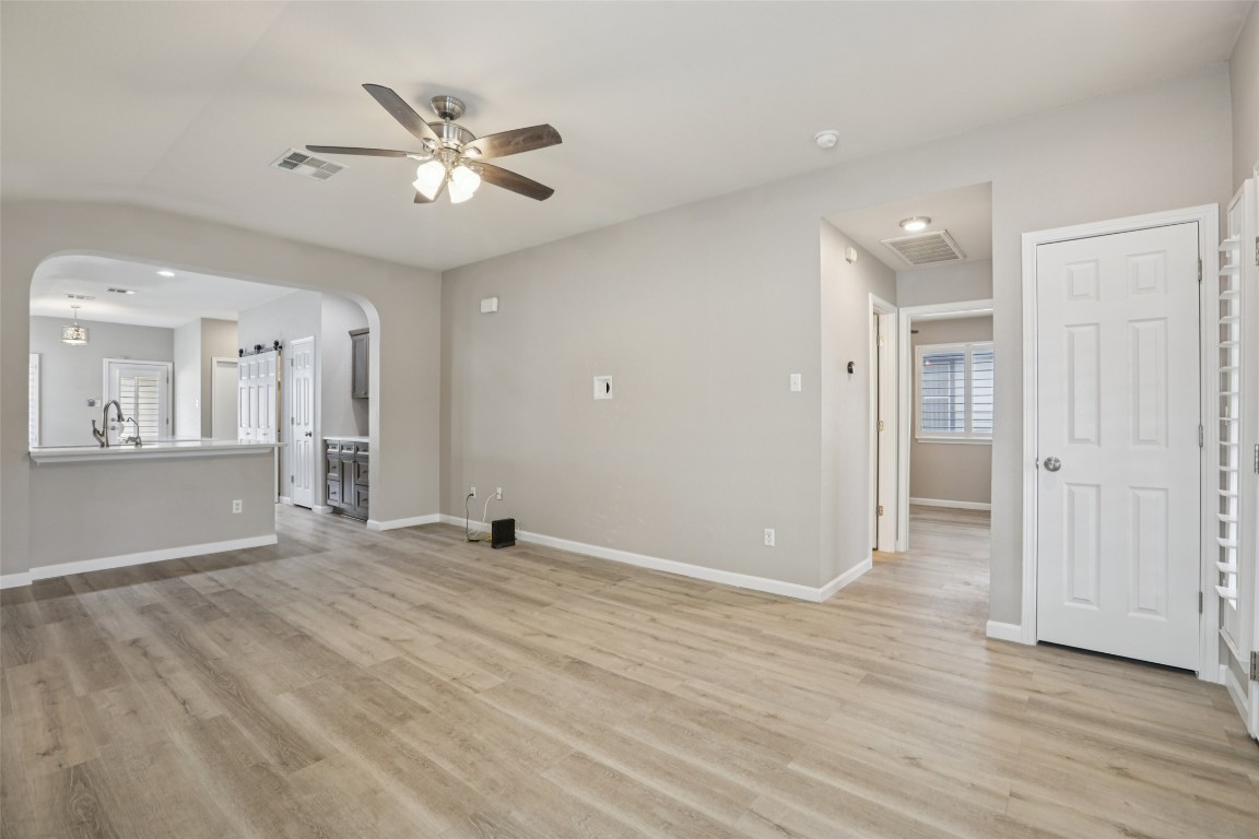 4937 Hartson Kyle, TX 78640 - Photo 11 of 40 a view of an empty room with wooden floor and a ceiling fan