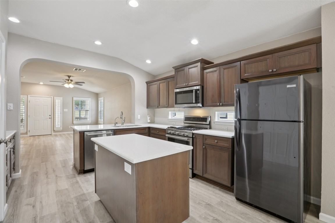 4937 Hartson Kyle, TX 78640 - Photo 15 of 40 a kitchen with kitchen island a counter top space a sink stainless steel appliances and cabinets