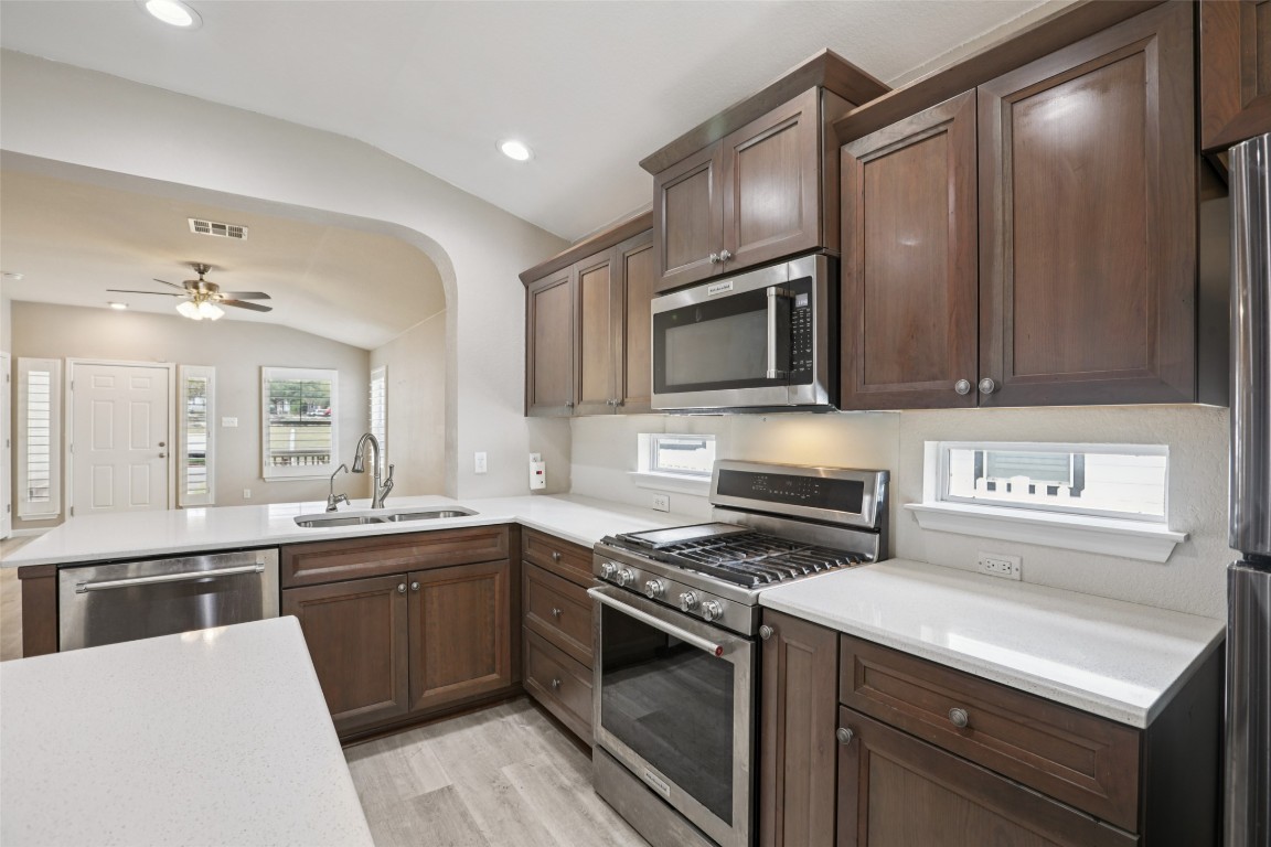 4937 Hartson Kyle, TX 78640 - Photo 16 of 40 a kitchen with stainless steel appliances a sink stove and refrigerator