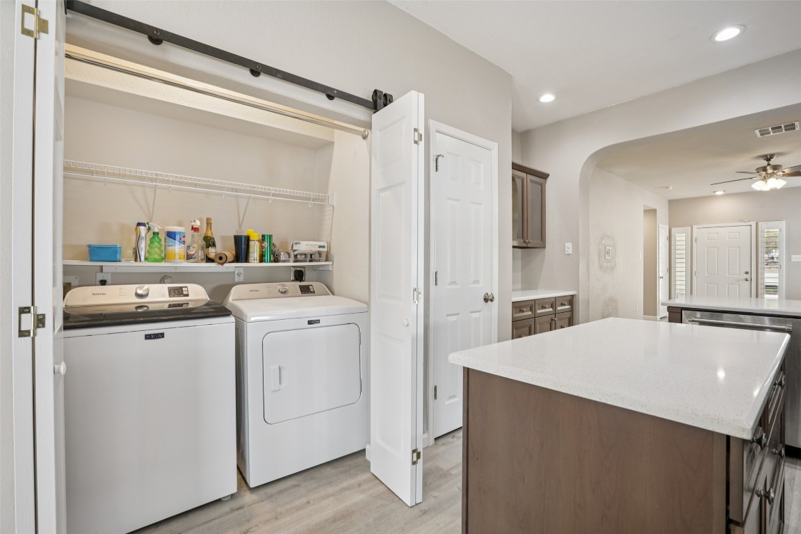 4937 Hartson Kyle, TX 78640 - Photo 34 of 40 a kitchen with a sink a stove a refrigerator and a cabinets
