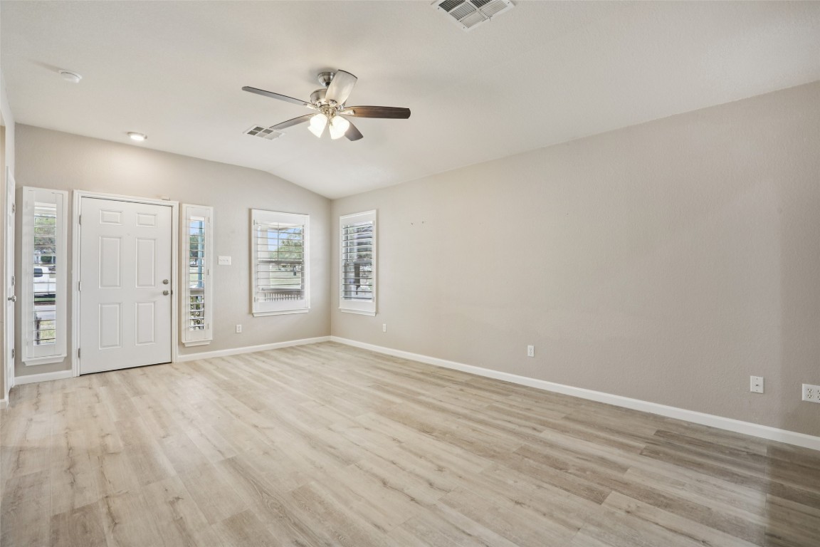 4937 Hartson Kyle, TX 78640 - Photo 8 of 40 a view of an empty room with wooden floor and a window