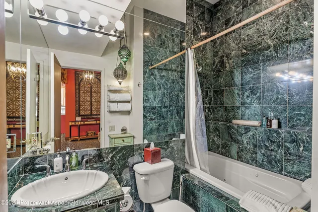 a bathroom with a sink mirror toilet and bathtub
