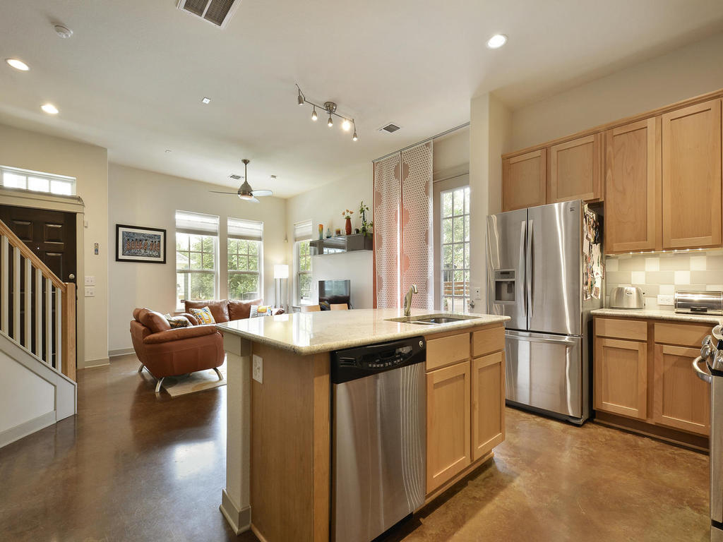 3900 Threadgill Street, Unit 32 Austin, TX 78723 - Photo 16 of 30 Polished concrete flooring sweeps through this open concept kitchen and adjoining living space.