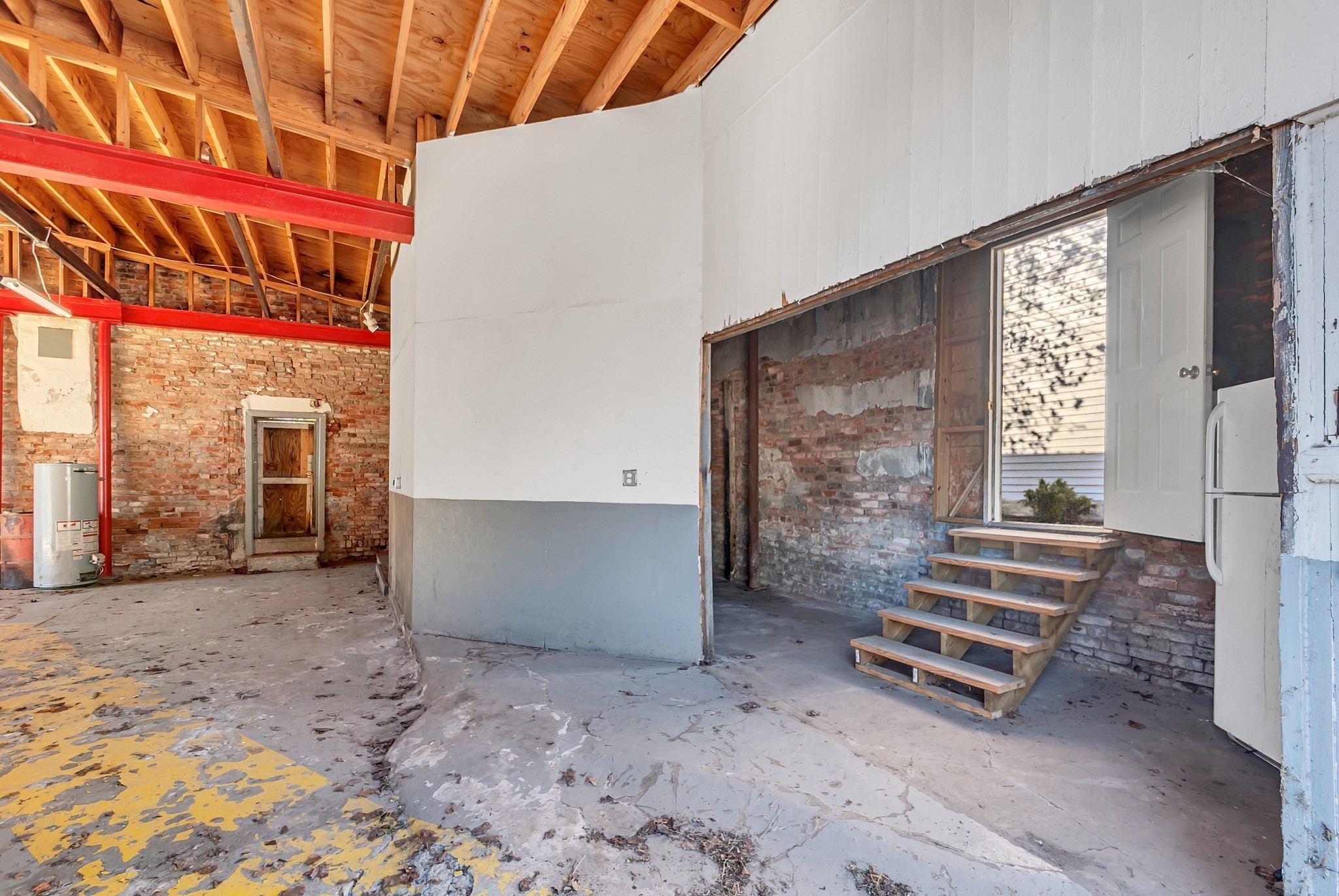 209 West 13th Street Columbia, TN 38401 - Photo 22 of 84 a view of an empty room with a fireplace and a window
