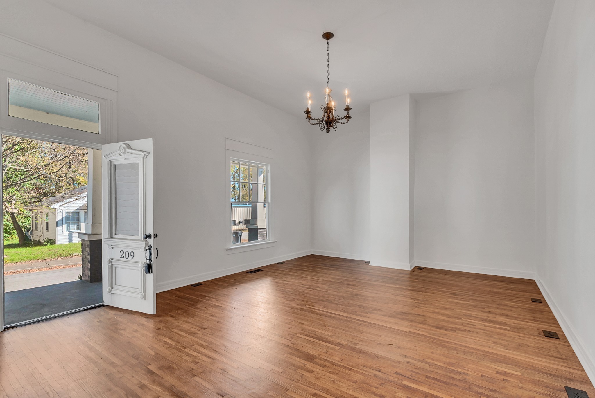 209 West 13th Street Columbia, TN 38401 - Photo 31 of 84 an empty room with wooden floor and windows