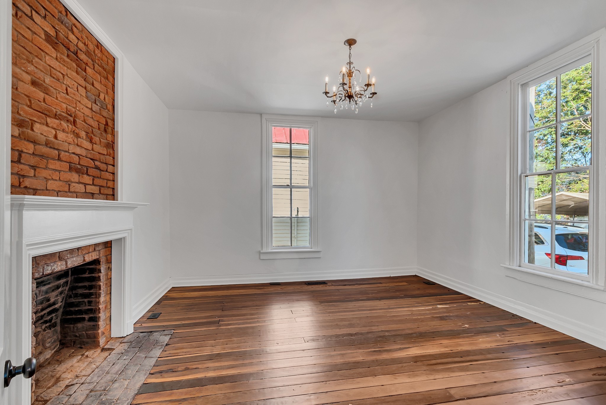 209 West 13th Street Columbia, TN 38401 - Photo 33 of 84 a view of an empty room with wooden floor and a window