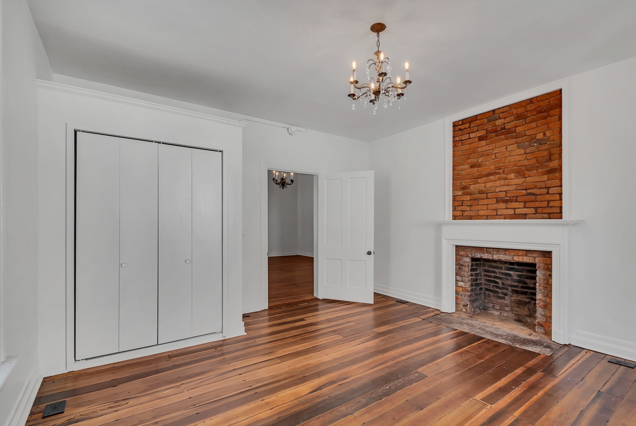 209 West 13th Street Columbia, TN 38401 - Photo 34 of 84 a view of an empty room with wooden floor and a fireplace