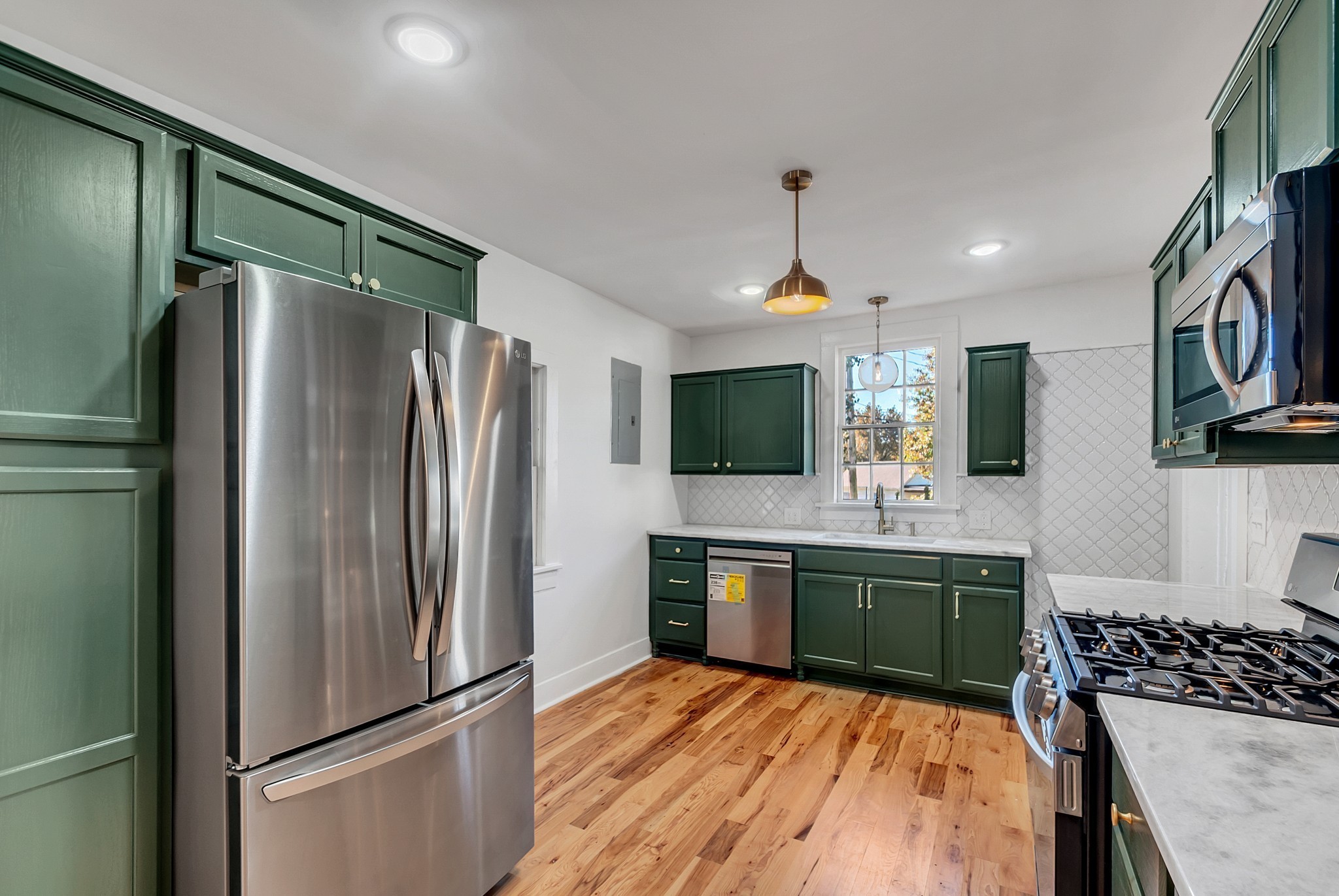 209 West 13th Street Columbia, TN 38401 - Photo 43 of 84 a kitchen with stainless steel appliances granite countertop a refrigerator and a stove top oven