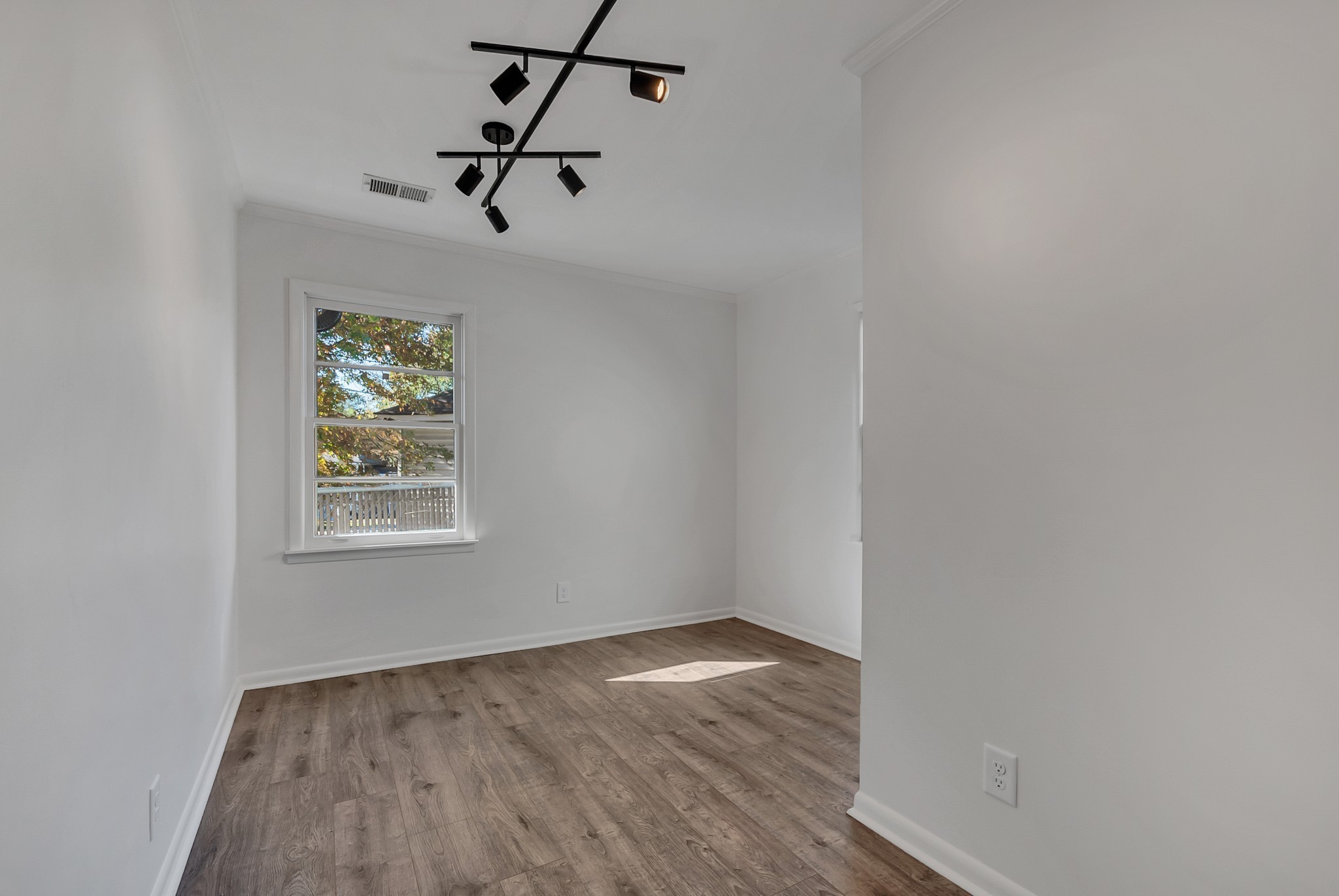 209 West 13th Street Columbia, TN 38401 - Photo 57 of 84 an empty room with wooden floor and windows