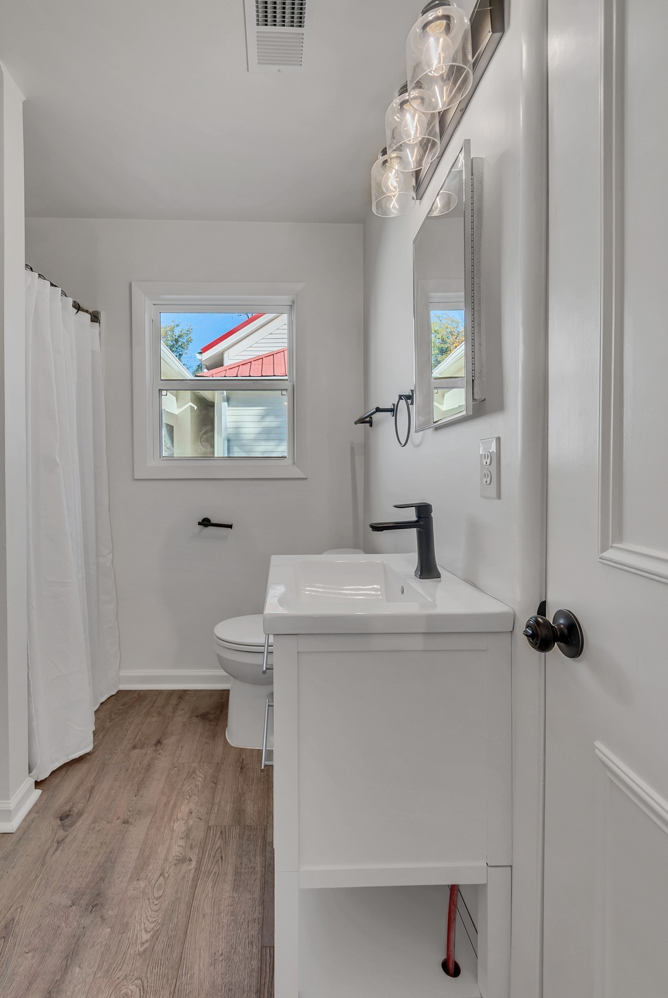 209 West 13th Street Columbia, TN 38401 - Photo 59 of 84 a bathroom with a sink a toilet and a mirror