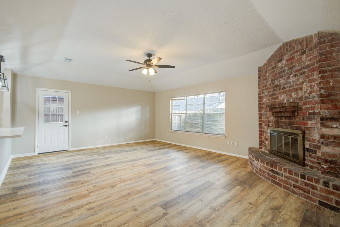 6722 Lynngate Drive Spring, TX 77373 - Photo 14 of 31 a view of an empty room with a fireplace and a window
