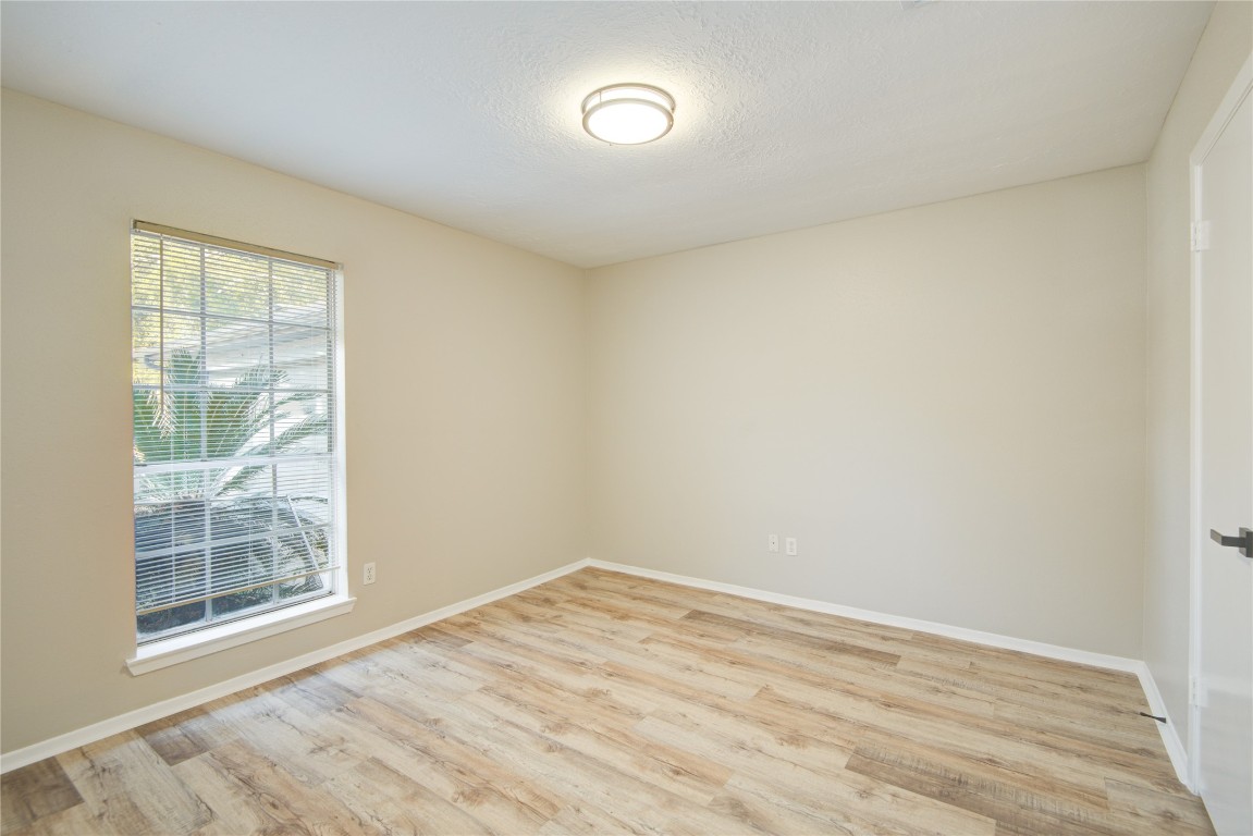 6722 Lynngate Drive Spring, TX 77373 - Photo 27 of 31 a view of empty room with wooden floor and fan