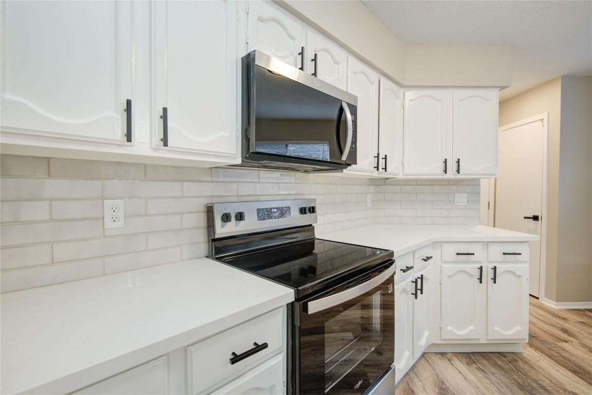 6722 Lynngate Drive Spring, TX 77373 - Photo 9 of 31 a kitchen with white cabinets and appliances
