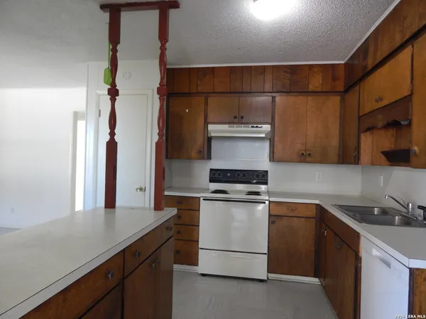 a kitchen with appliances cabinets and a sink