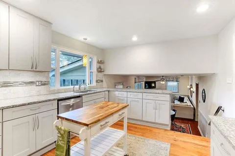 a kitchen with stainless steel appliances granite countertop a sink and cabinets