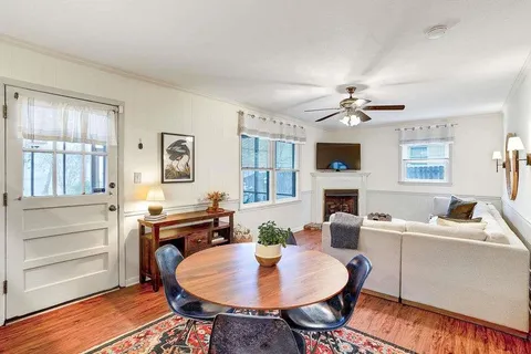 a living room with fireplace furniture and a window