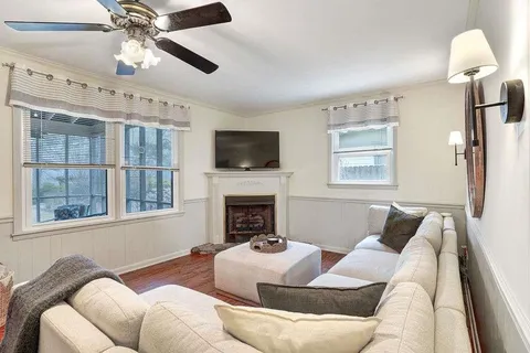 a living room with furniture fireplace and a flat screen tv