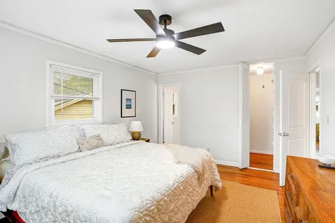 a bedroom with a large bed and a chandelier