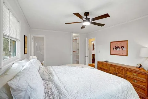 a bedroom with a large bed and a large mirror