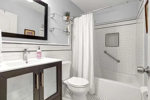 a bathroom with a sink toilet and shower