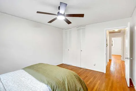 a bedroom with a large bed and a chandelier