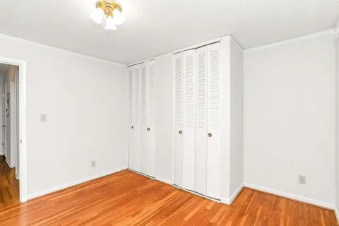 a view of a room with wooden floor and small space