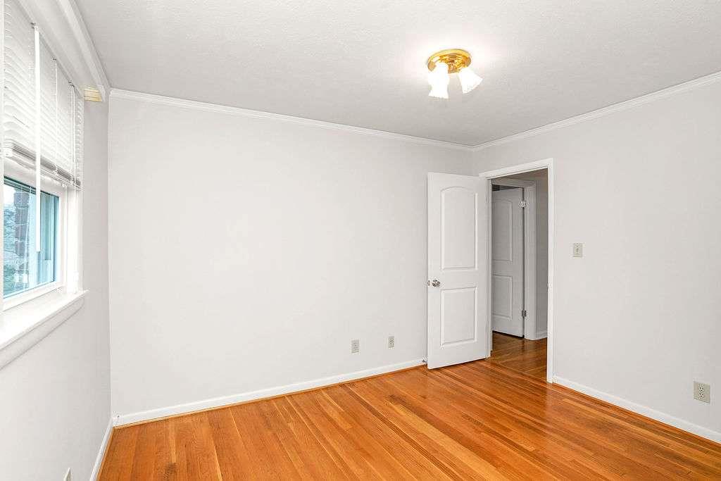 2889 Rotherwood Drive Tucker, GA 30084 - Photo 32 of 49 a view of an empty room with wooden floor and a window