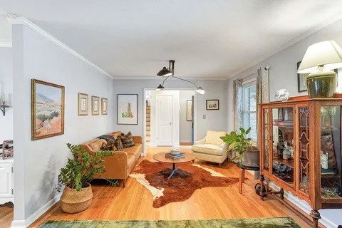 a living room with furniture and a chandelier