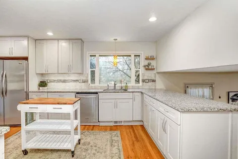 a kitchen with a sink stove and cabinets