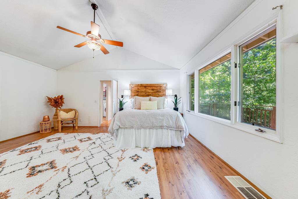 168 Riverside Drive Boulder Creek, CA 95006 - Photo 20 of 52 a bedroom with a bed and wooden floor